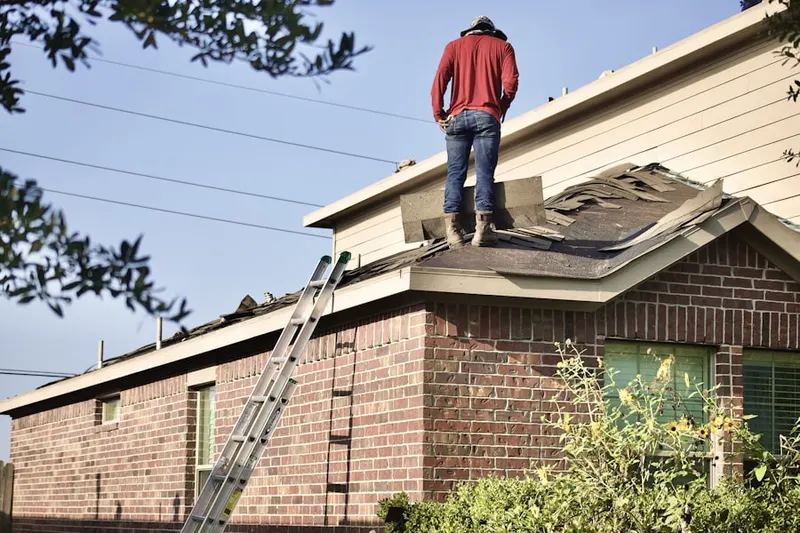 Professional roofer working on a residential roof in Briarwood Senior Housing